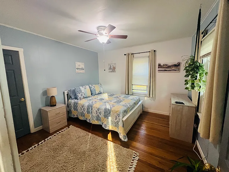 First floor bedroom with closet, Queen bed, dressers, A/C, and TV
