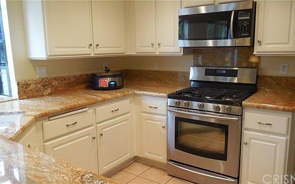 Beautiful white cabinets and stainless steel appliances.