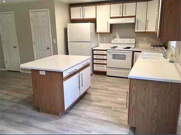 Large kitchen with plenty of storage and island with bar seating.