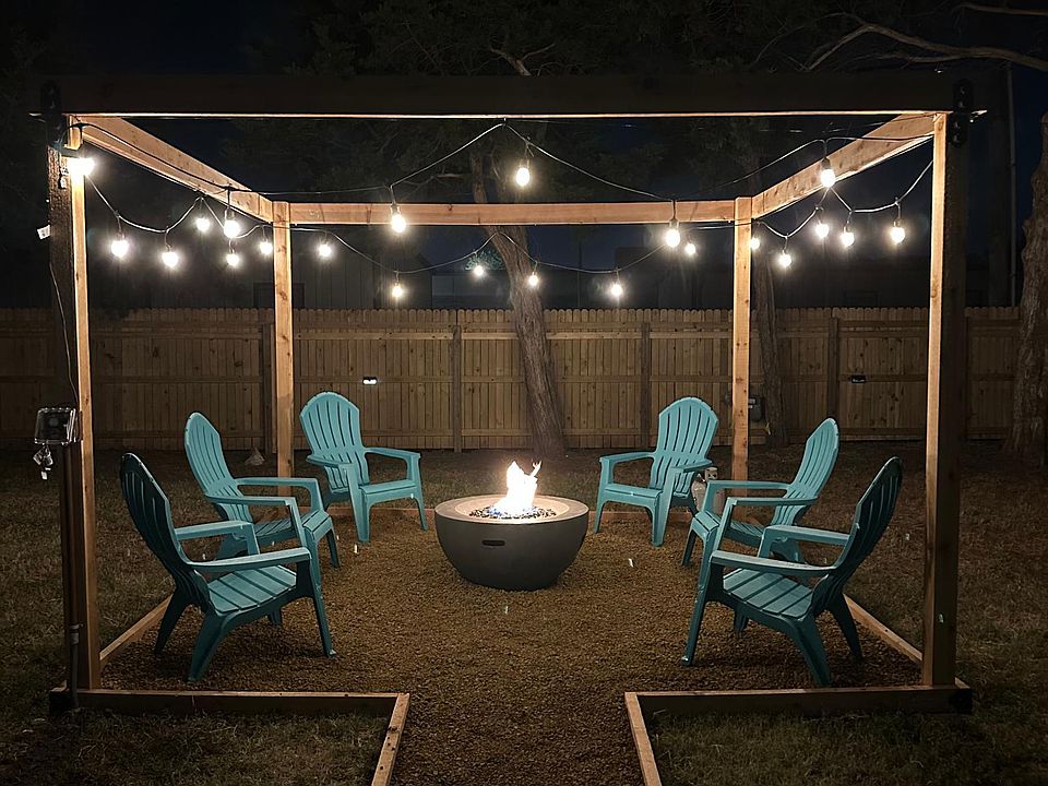 Fenced in backyard with gas-fueled fire pit.