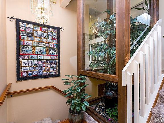Atrium entry with skylight and front window - left to the lower level and right to the main living area.