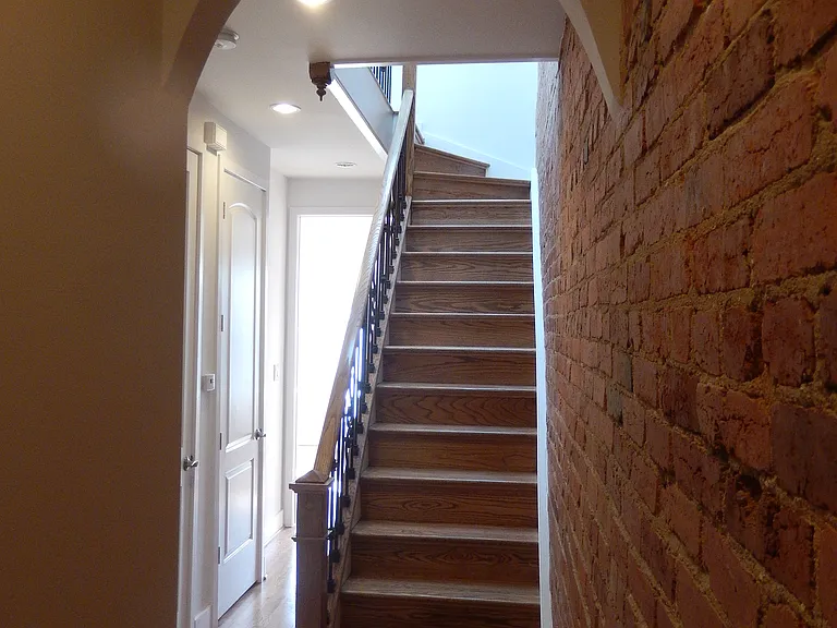 Archway covered staircase to third floor.