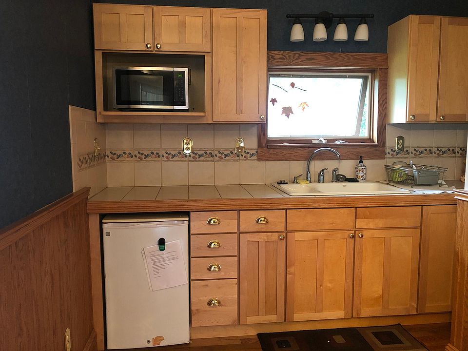 Kitchen area, west facing window. Small fridge and microwave.