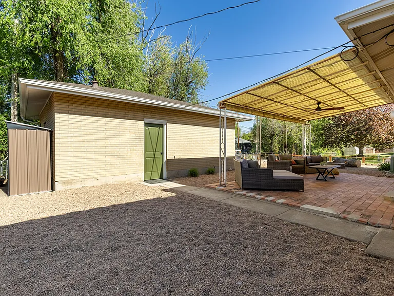 Private detached cottage house with access to a large, shared backyard space. The backyard has a large awning, allowing tenant ample privacy and shade to enjoy the outdoor space anytime of day.