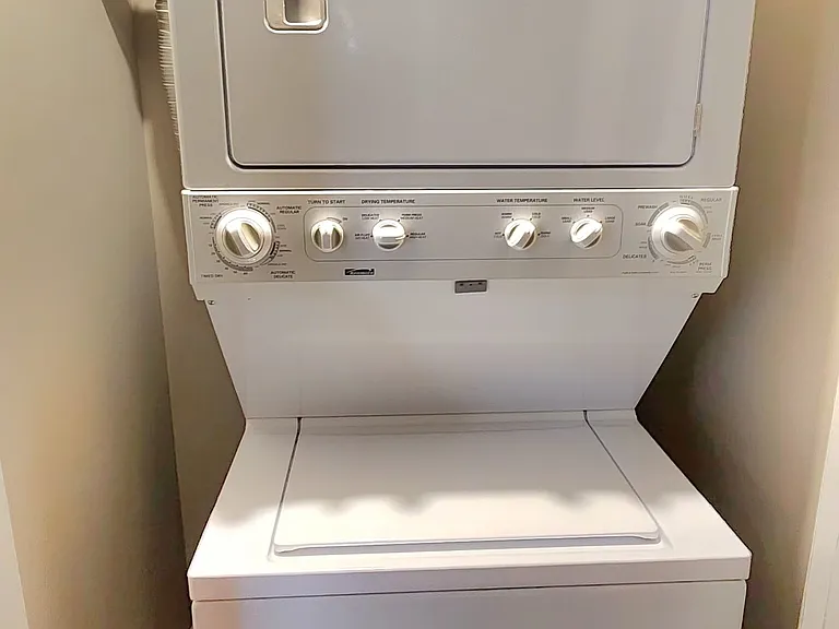 Stack washer/dryer, which is next to the bathroom. A door closes to cover this area.