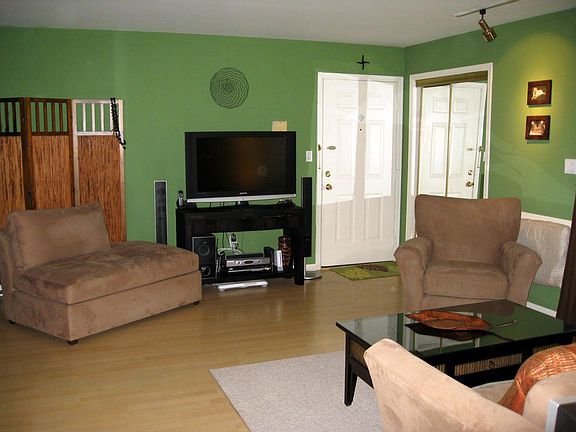 Unit entrance door with mirrored sliding door closet and open flow living/dining space.