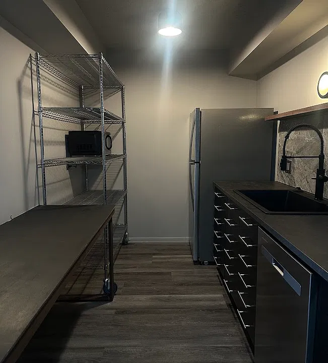 Auxiliary wire rack storage with microwave included. Full sized fridge with above freezer.