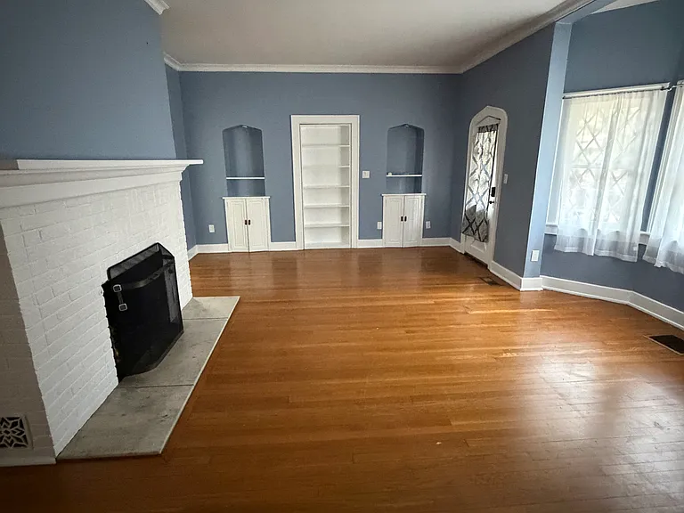 Front room from wall opposite entrance. Built in cabinets