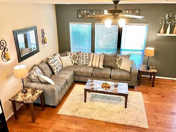 The living area is open to the kitchen and has engineered hardwood floors.