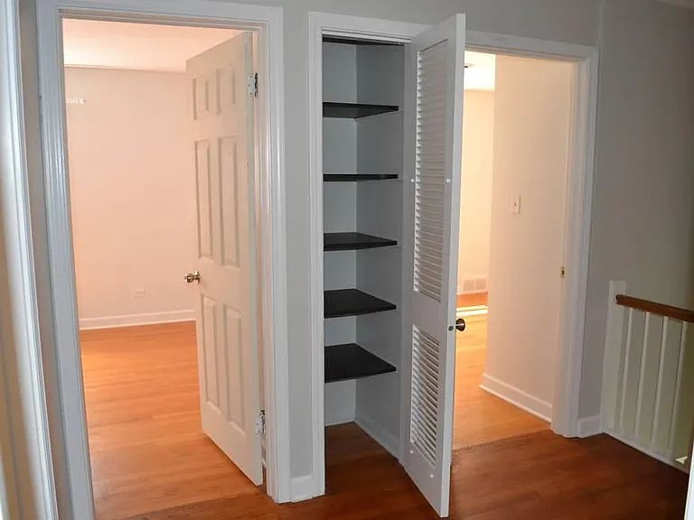 Upper Level - Hallway. Shows two bedrooms and linen closet