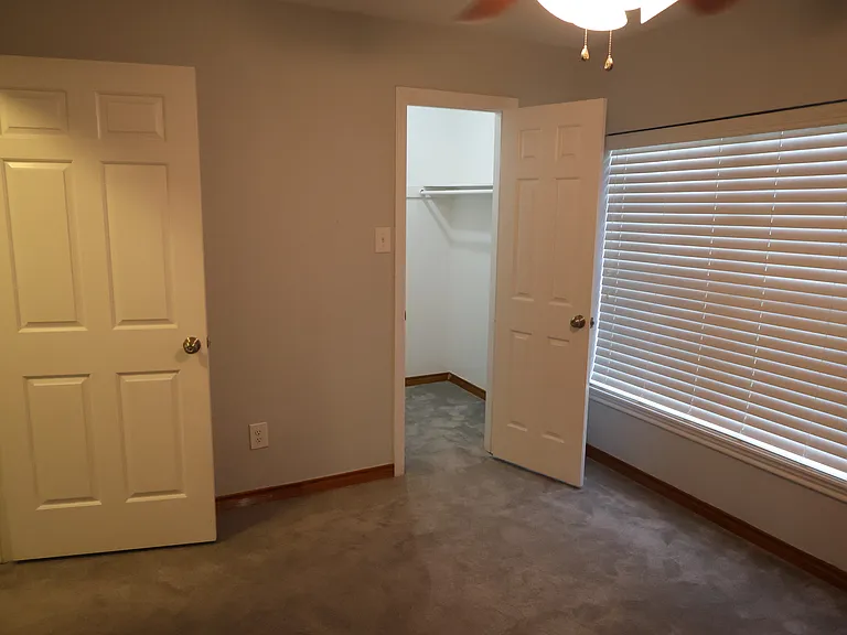 Bedroom #3 with ceiling fan and walk-in closet.
