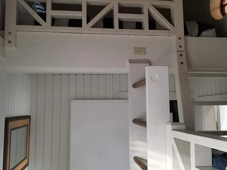 Bunk bed room has 2 twins and a queen mattress in the loft above the twins