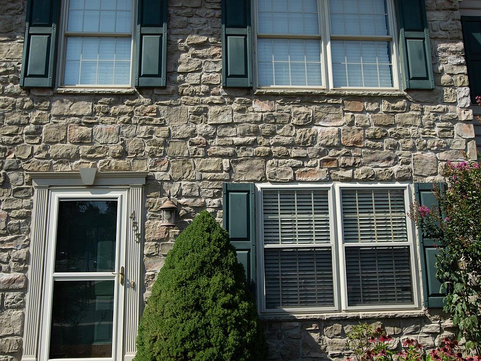 Stone front with flowers garden.