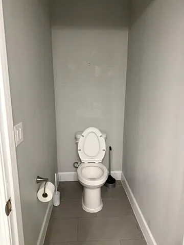 upstairs private toilet within oversized bathroom