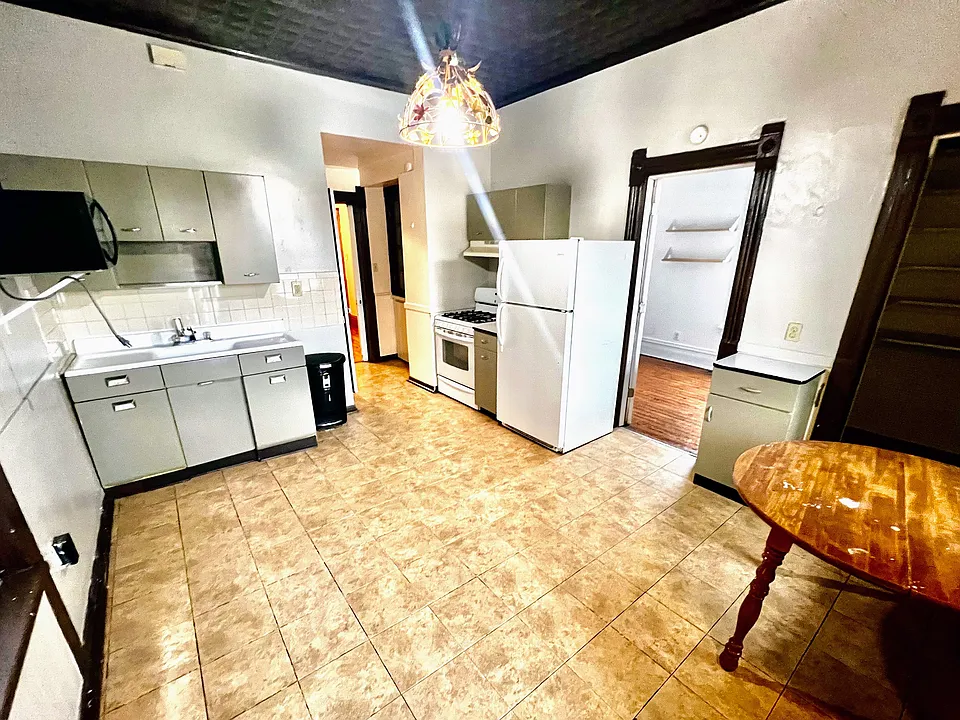 Kitchen, doorway next to fridge to 3rd bedroom.