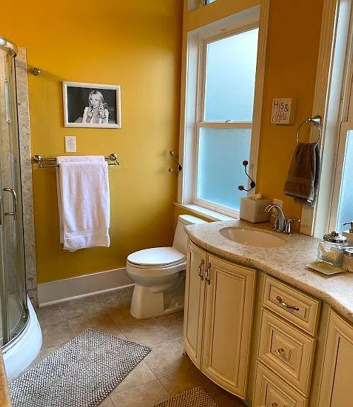 2 sinks, toilet, shower stall, and makeup vanity.
