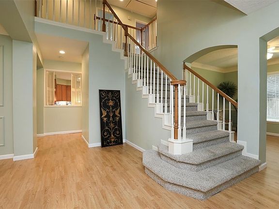 ENTRY SHOWING OPEN STAIRS - DINING ROOM IN VIEW