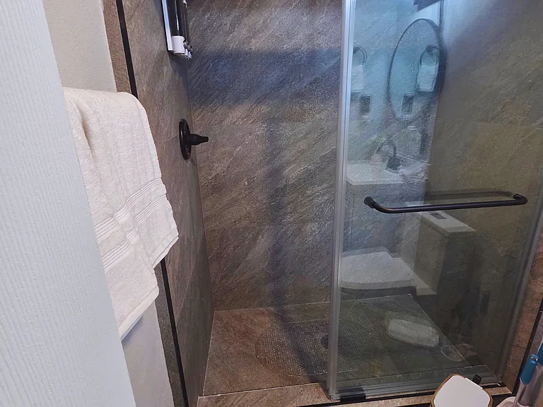 Bright modern bathroom with towel racks and storage cabinet
