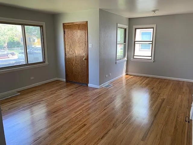 Front entrance door and living room and dining room with ceiling fan/light