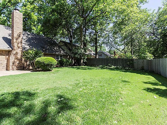 Additional view of park like shaded backyard.