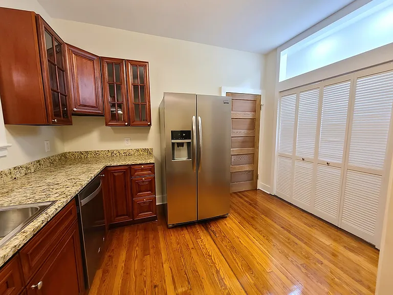 Large bifold door pantry with adjustable shelving and lighting.