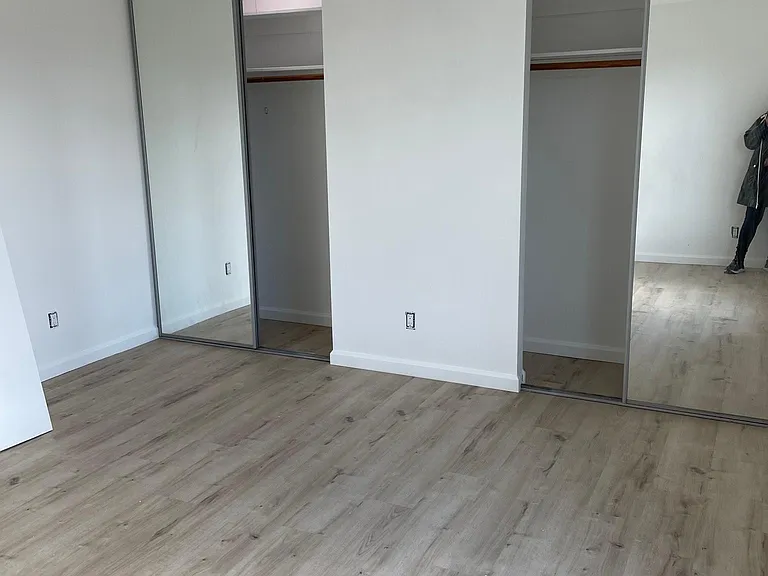 BEDROOM WITH WALL TO WALL CLOSETS