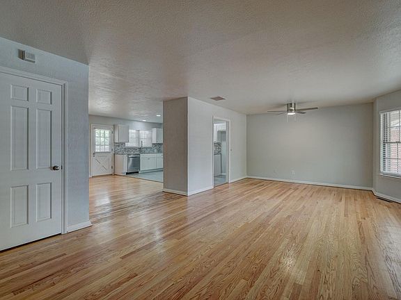 View from the front door into the living room straight ahead, and dining room and kitchen to the left.