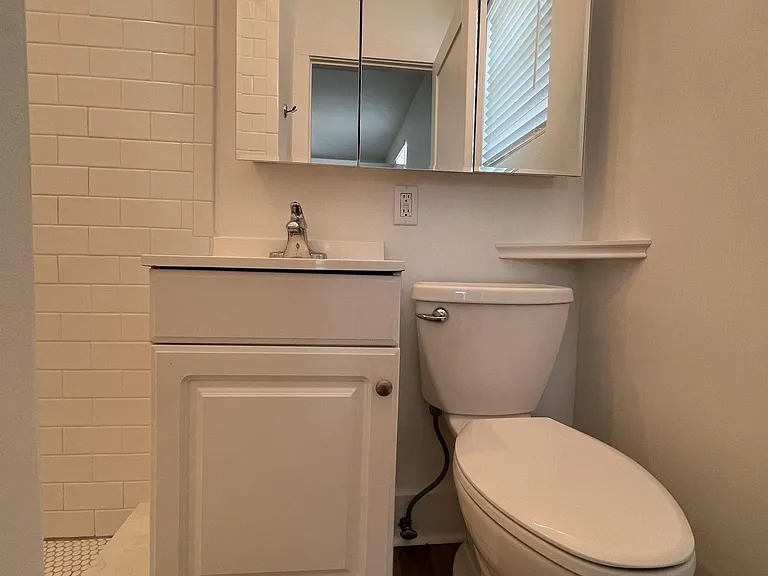 Bright, clean bathroom with 36" wide medicine cabinet and LED vanity light.