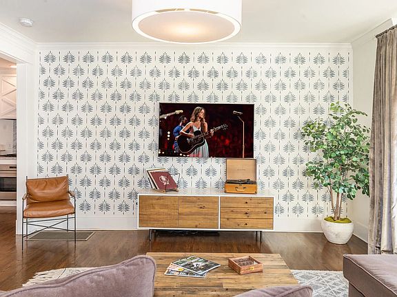 Open-concept living and dining area with hardwood floors and natural light throughout