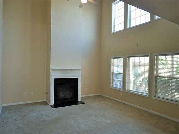 Living room with fireplace and high vaulted ceilings.
