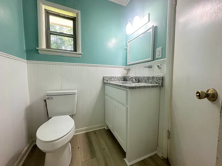 Bathroom - new Vanity, toilet, flooring, and vent fan/light