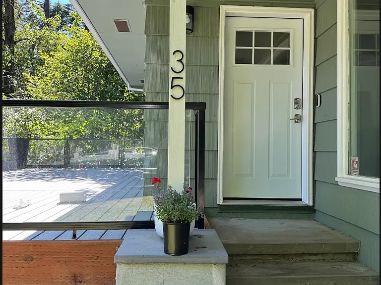 A beautifully landscaped entry and colorful garden beds create a warm welcome home.