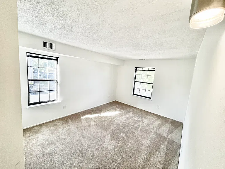 First bedroom with tons of natural sunlight and windows on two walls (corner unit)