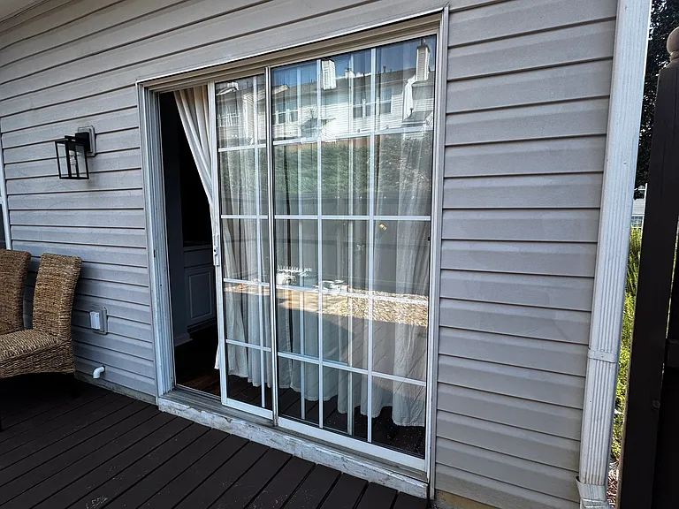 outdoor patio with a private fenced yard and an additional storage room.