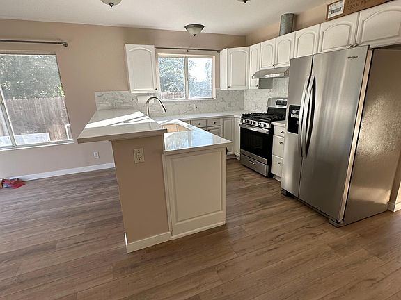 Kitchen with new side-by-side stainless steel refrigerator