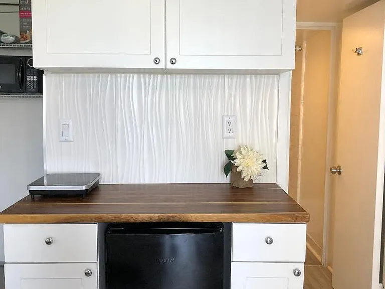 Meal prep area with Microwave, coffee maker, burner, pots/pans/dishes/glasses, rice cooker, etc.