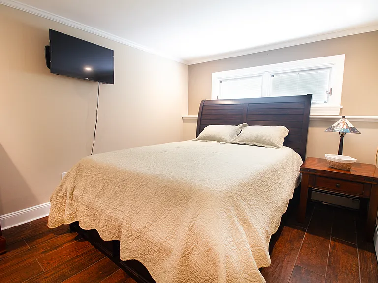King size bed with drawers underneath and a TV in your bedroom.