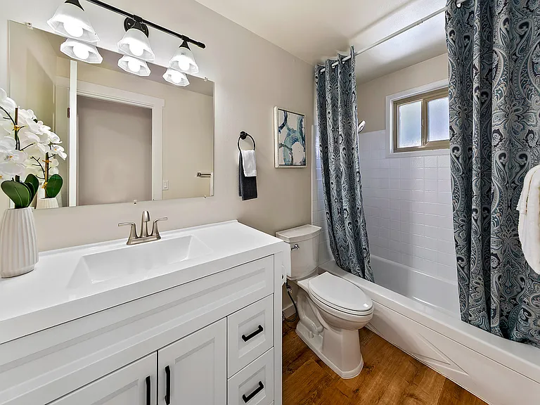 Updated bathroom with a new modern vanity and toilet.