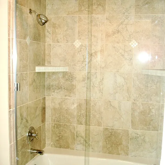 Tiled tub/shower combo with glass doors