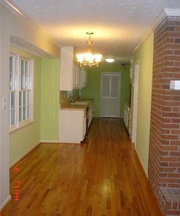Long view of breakfast nook leading into kitchen and separate laundry