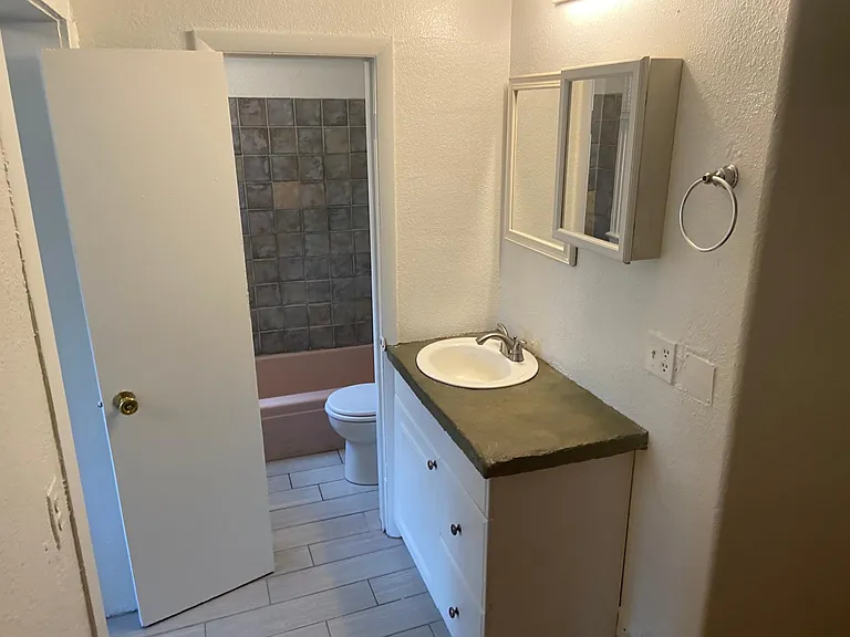 Bathroom vanity leading into bath