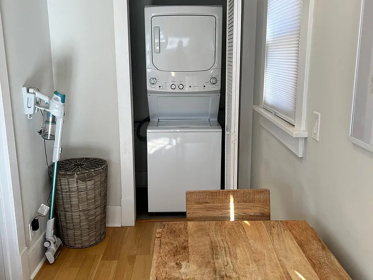 Washer & Dryer and stick vacuum. Seating area for the kitchen.