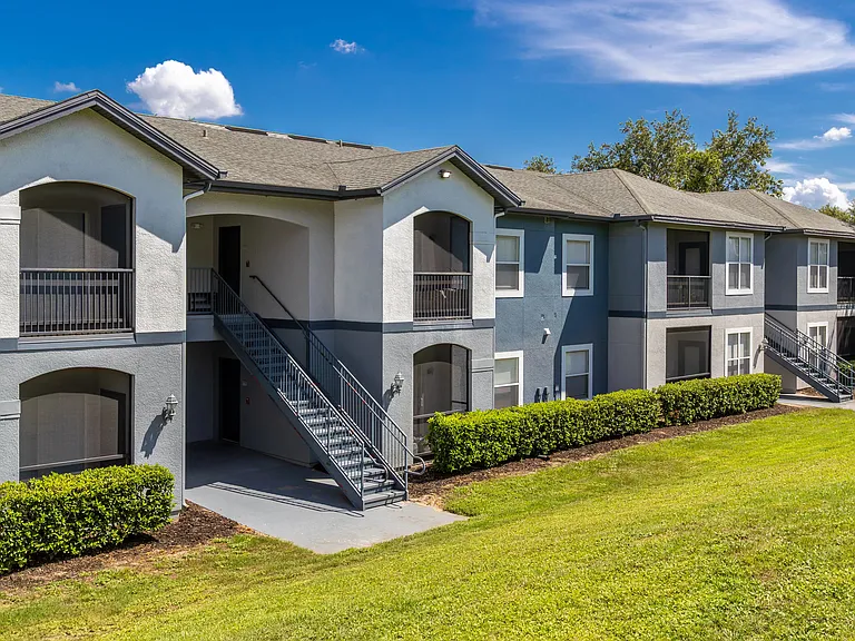 Discover the contemporary charm of Elevate 155 with freshly painted exteriors, private screened-in patios, and lush green surroundings.