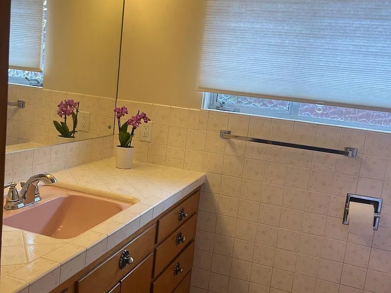Main bathroom has lots of cabinet space.
