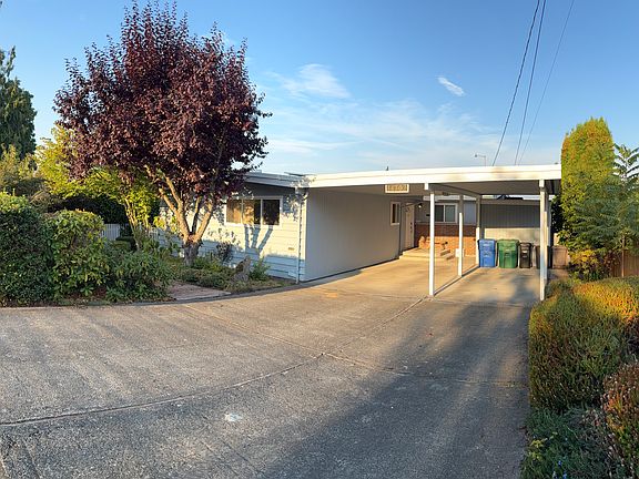 Front of house with 2-car carport and driveway (6 tandem parking spots)