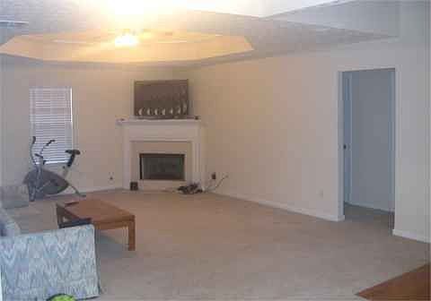 Family room has marble fireplace and hardwood floors in the entry foyer