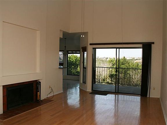Main level living room with wood floors and fireplace.