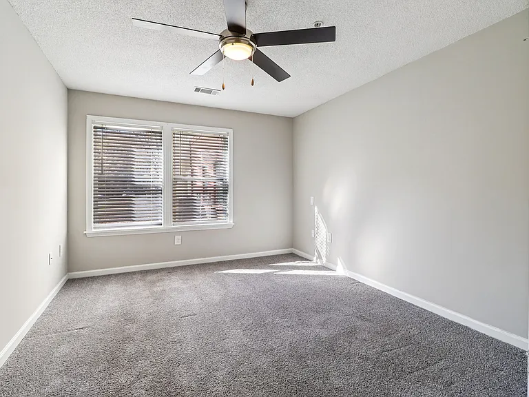 Cozy rooms feature plush carpeting and ceiling fans for year-round comfort, professionally operated by Highlands Vista Group.