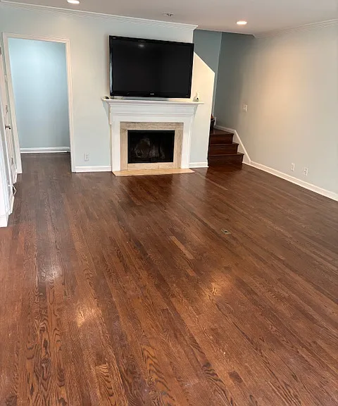 Living Room as you walk in with fireplace and TV and 1/2 Bath