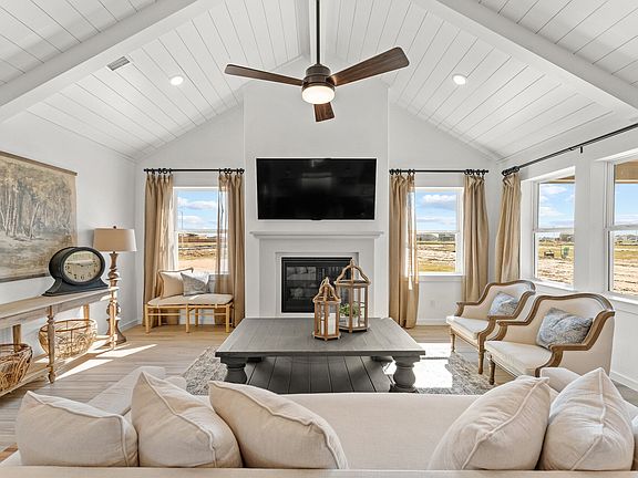 Great room with white painted shiplap and vaulted ceiling